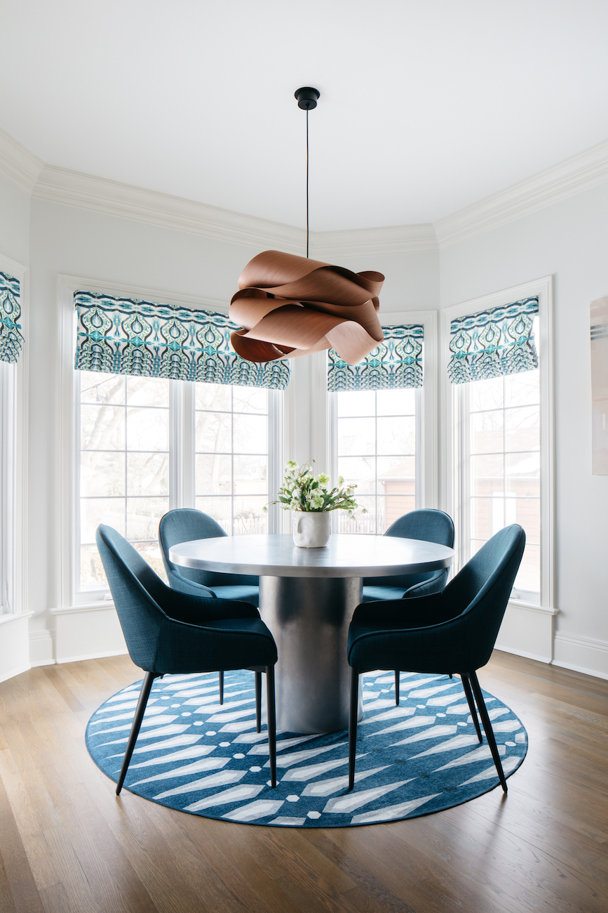 round-dining-table-blue-chairs-rug-chandelier-glen-ellyn-il