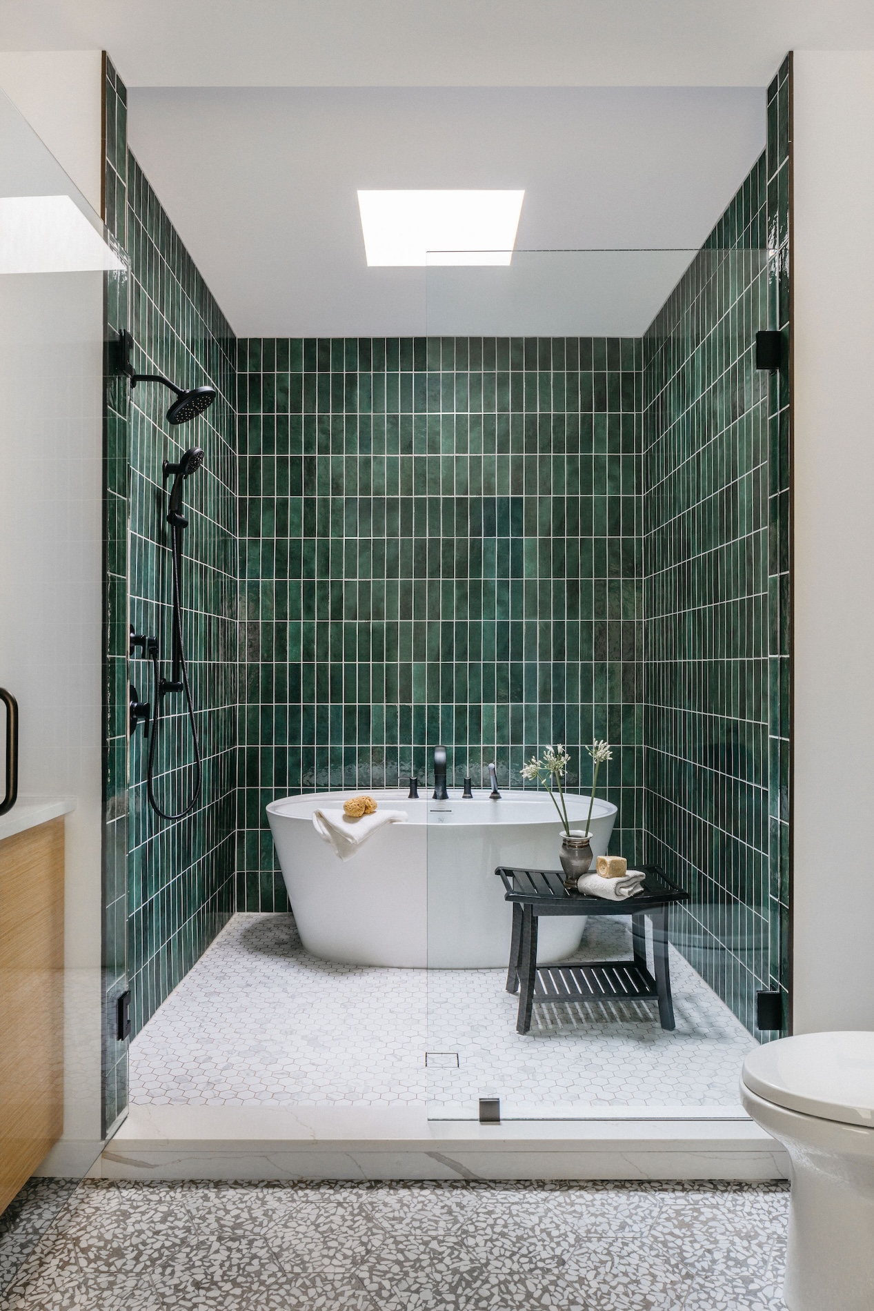 bathroom-tub-in-large-shower-with-green-tile