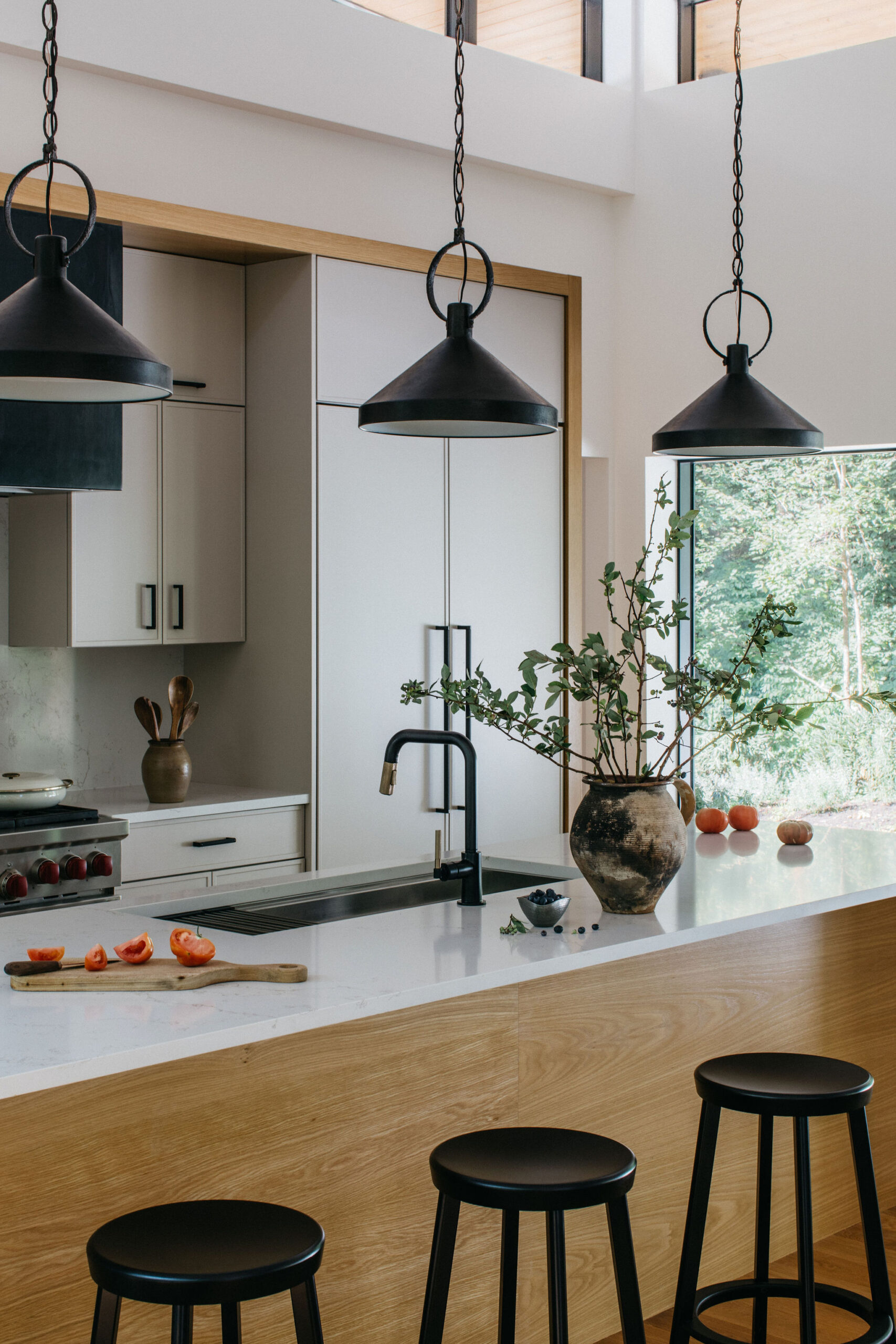 kitchen-island-with-black-stools-and-hanging-black-lights