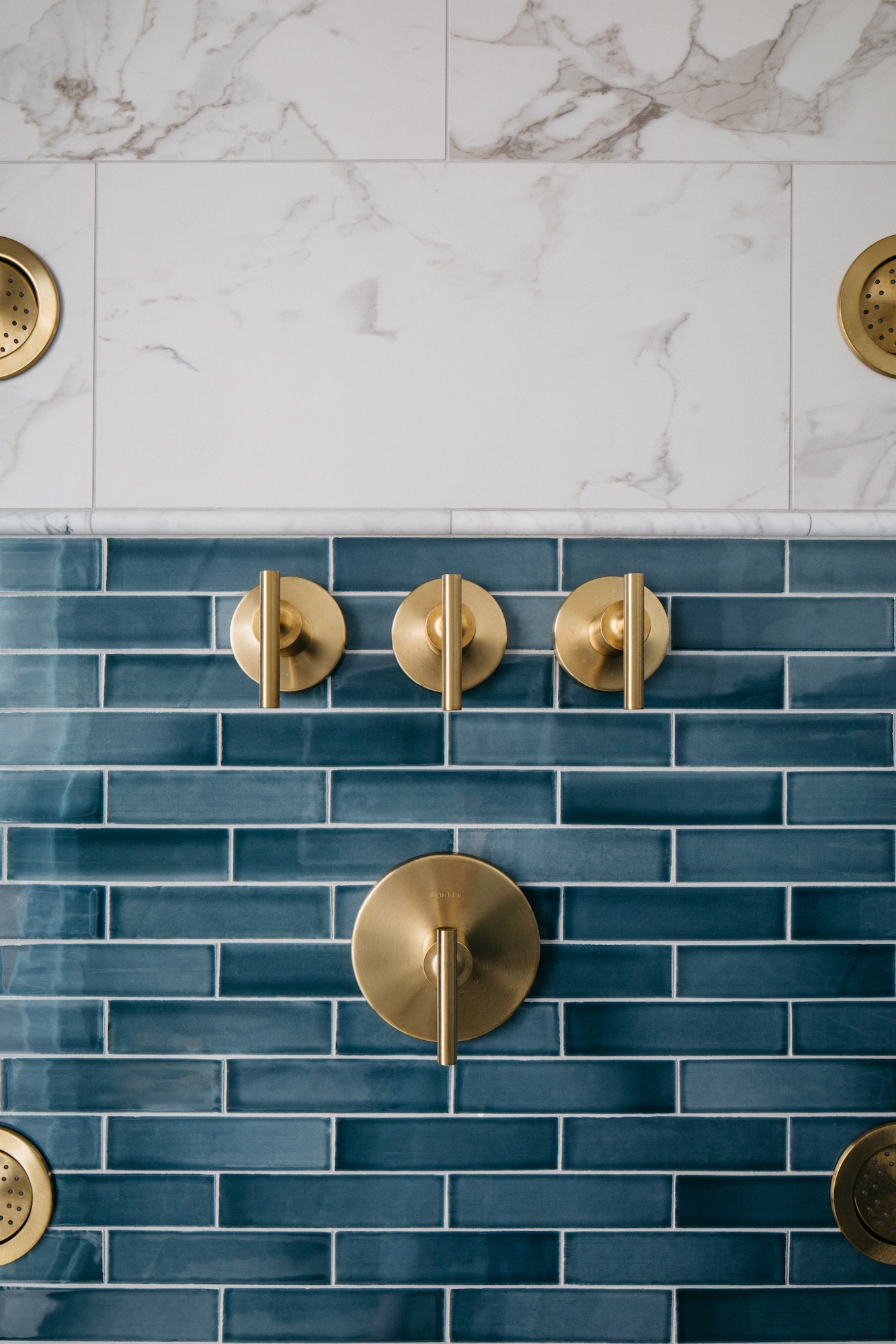 blue-tile-gold-hardware-faucet-shower