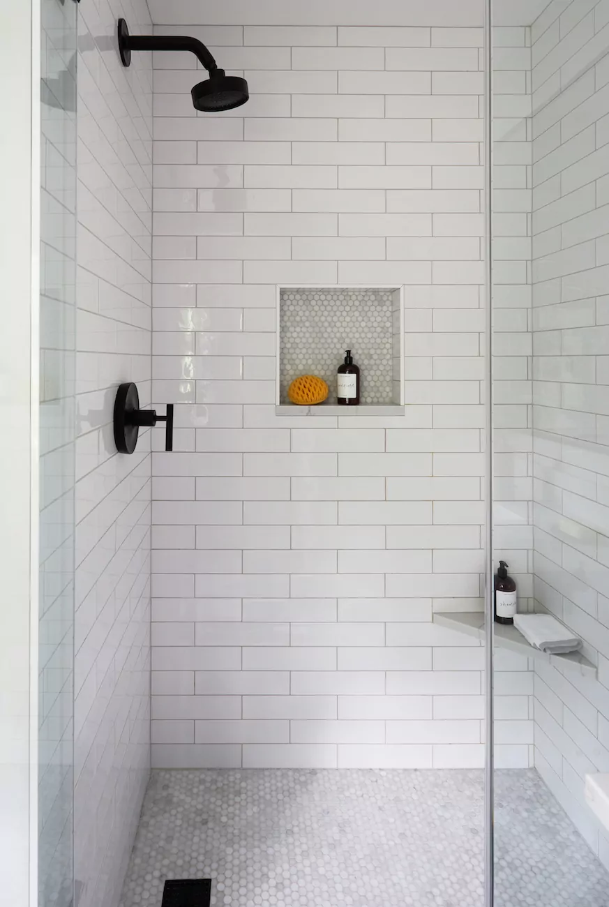 white-tile-shower-black-showerhead-hardware